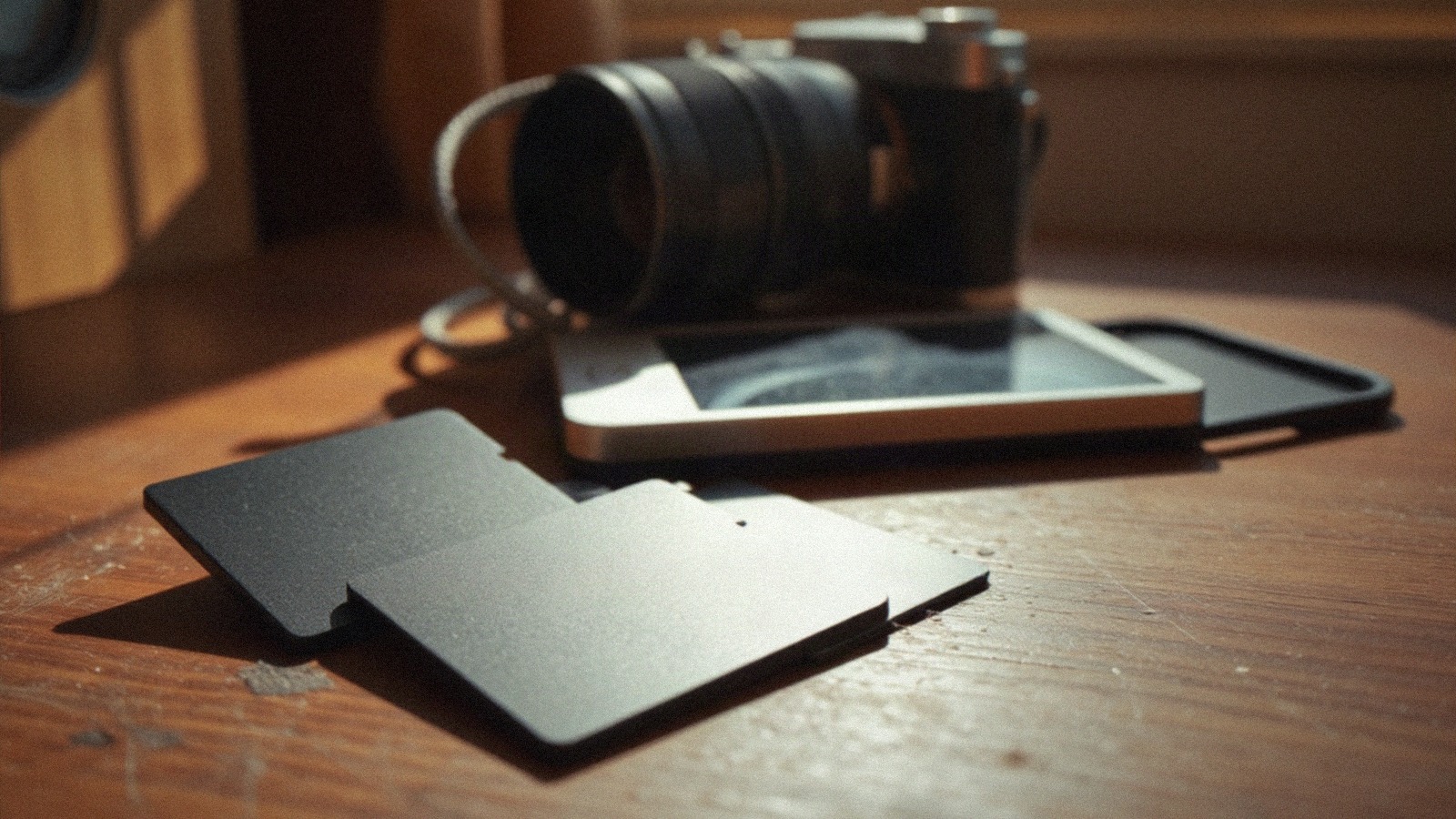 Three blank SD memory cards on a desk in late-afternoon window light. NAND flash is the storage inside phones, laptops and the enterprise drives now bolted into AI data centers. Photo: The Signal / AI-generated.